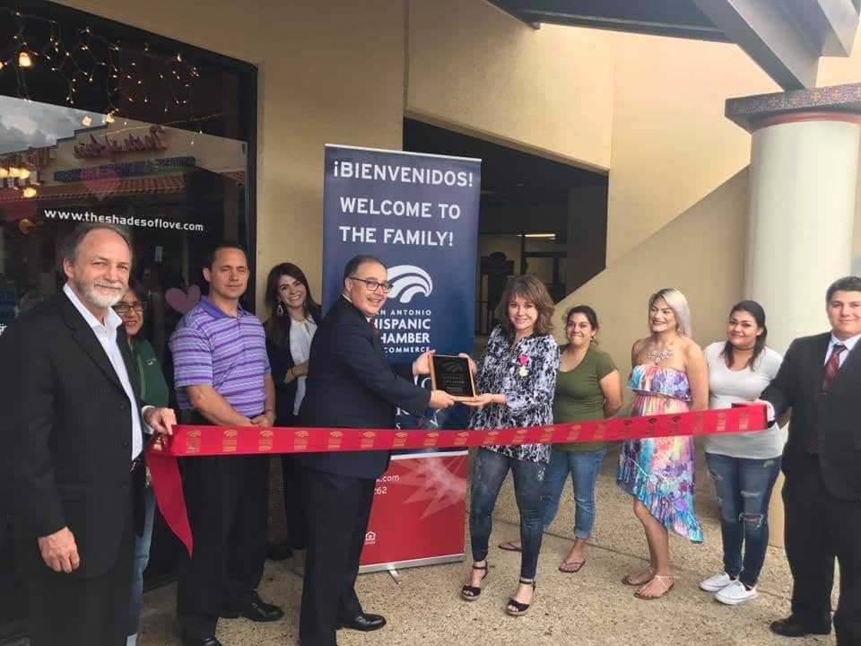 rita delgado receives a plaque from the hispanic chamber of commerce