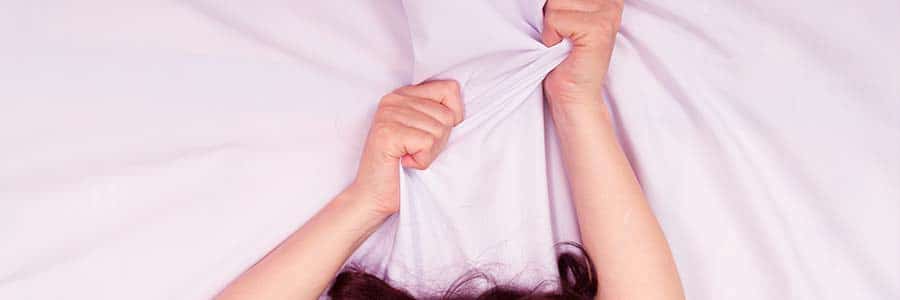 two-hands-grabbing-onto-a-white-sheet